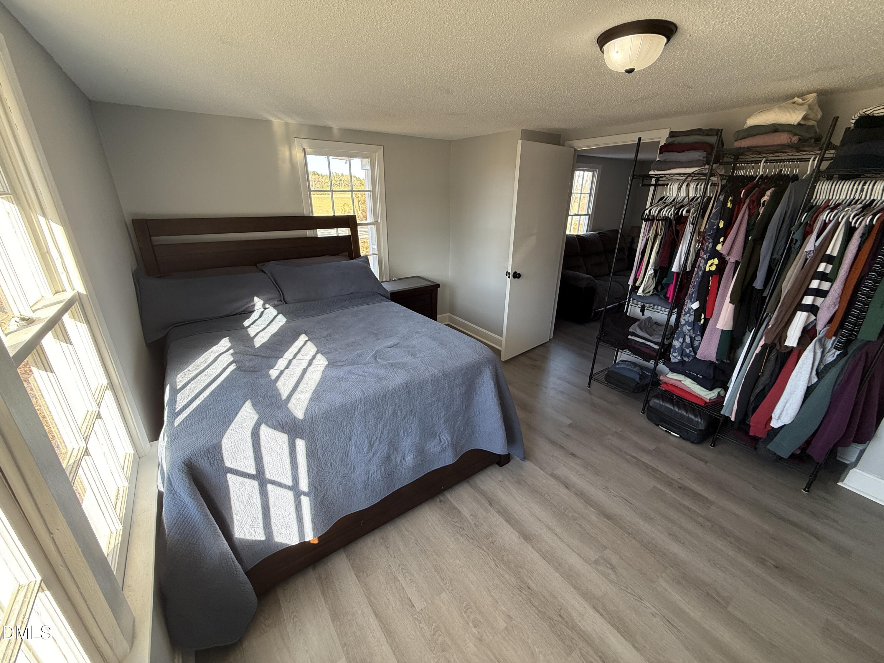 895 Stewart Road Four Oaks, NC 27524 - Photo 17 of 38 a bedroom with bed and a window