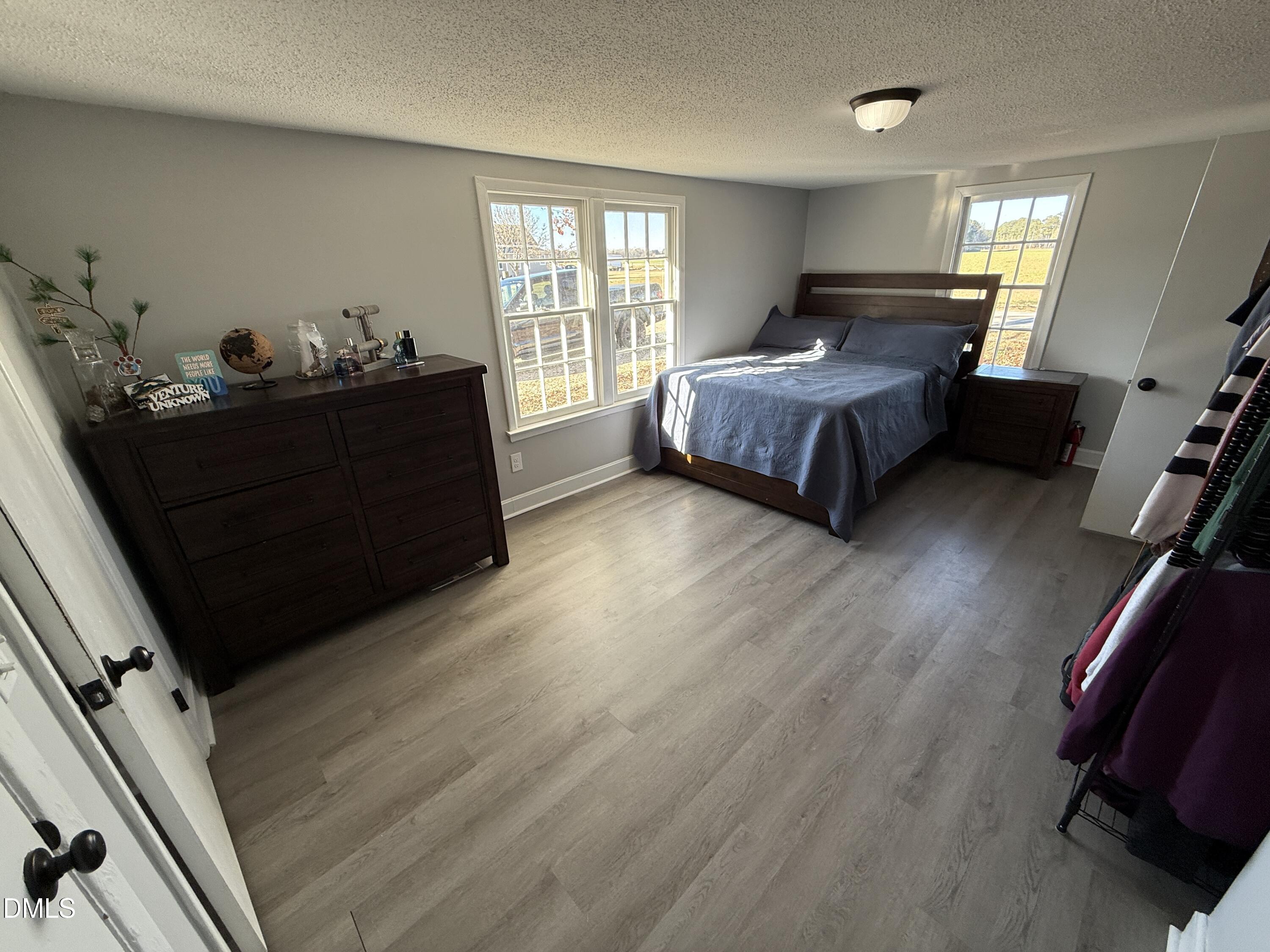895 Stewart Road Four Oaks, NC 27524 - Photo 18 of 38 a bedroom with a bed and window