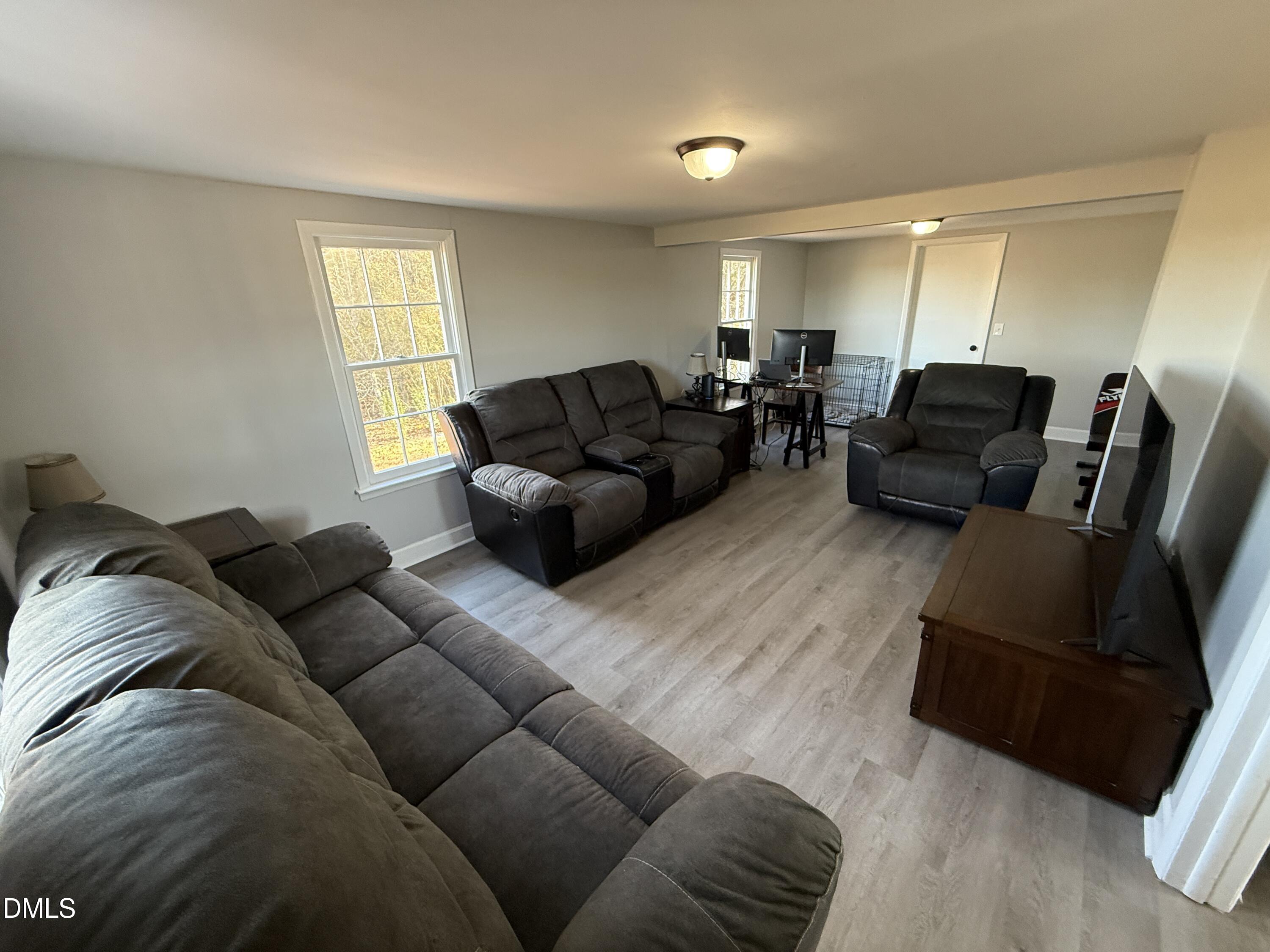 895 Stewart Road Four Oaks, NC 27524 - Photo 2 of 38 a living room with furniture and a window
