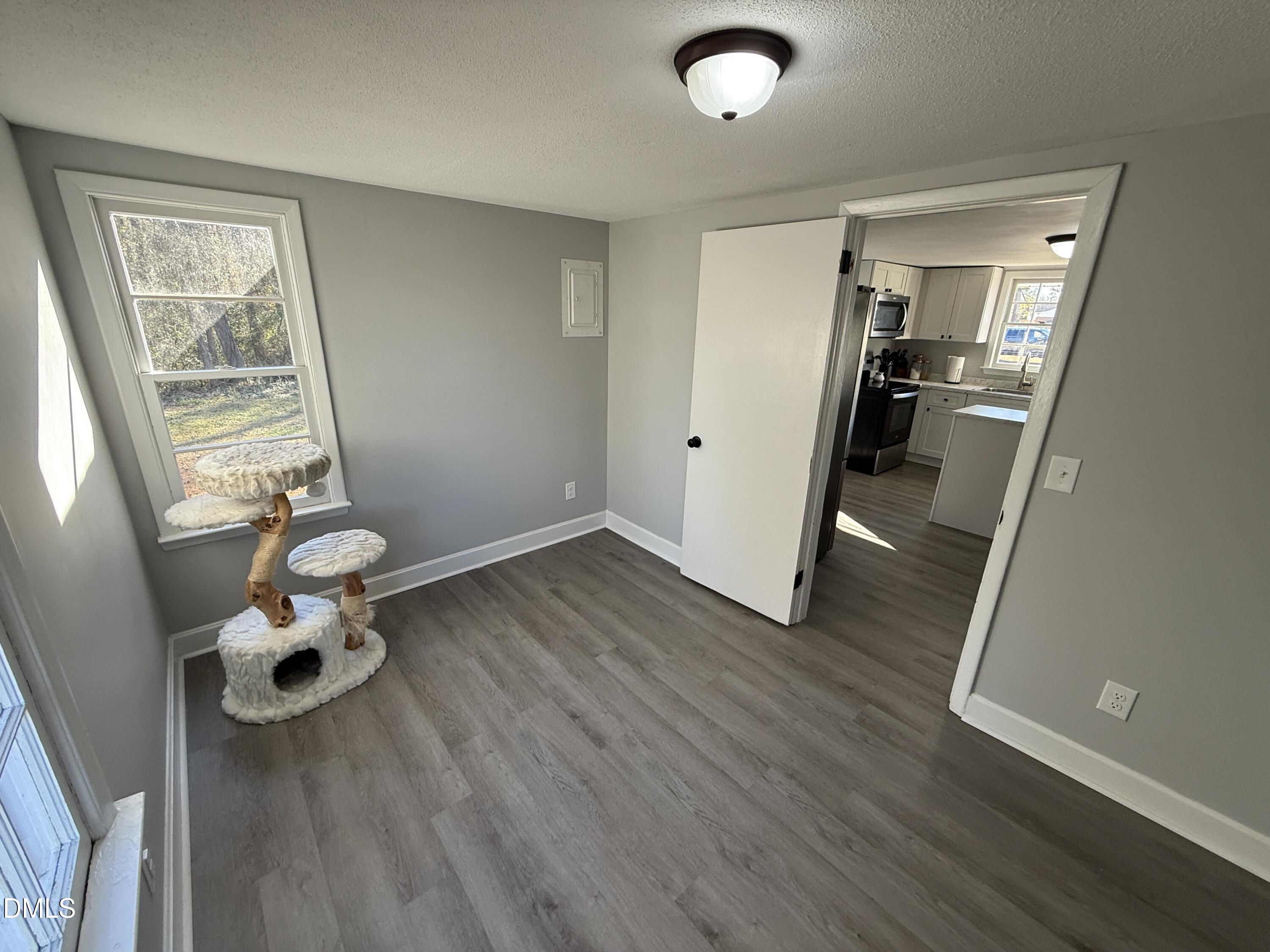 895 Stewart Road Four Oaks, NC 27524 - Photo 22 of 38 wooden floor in an empty room and a window