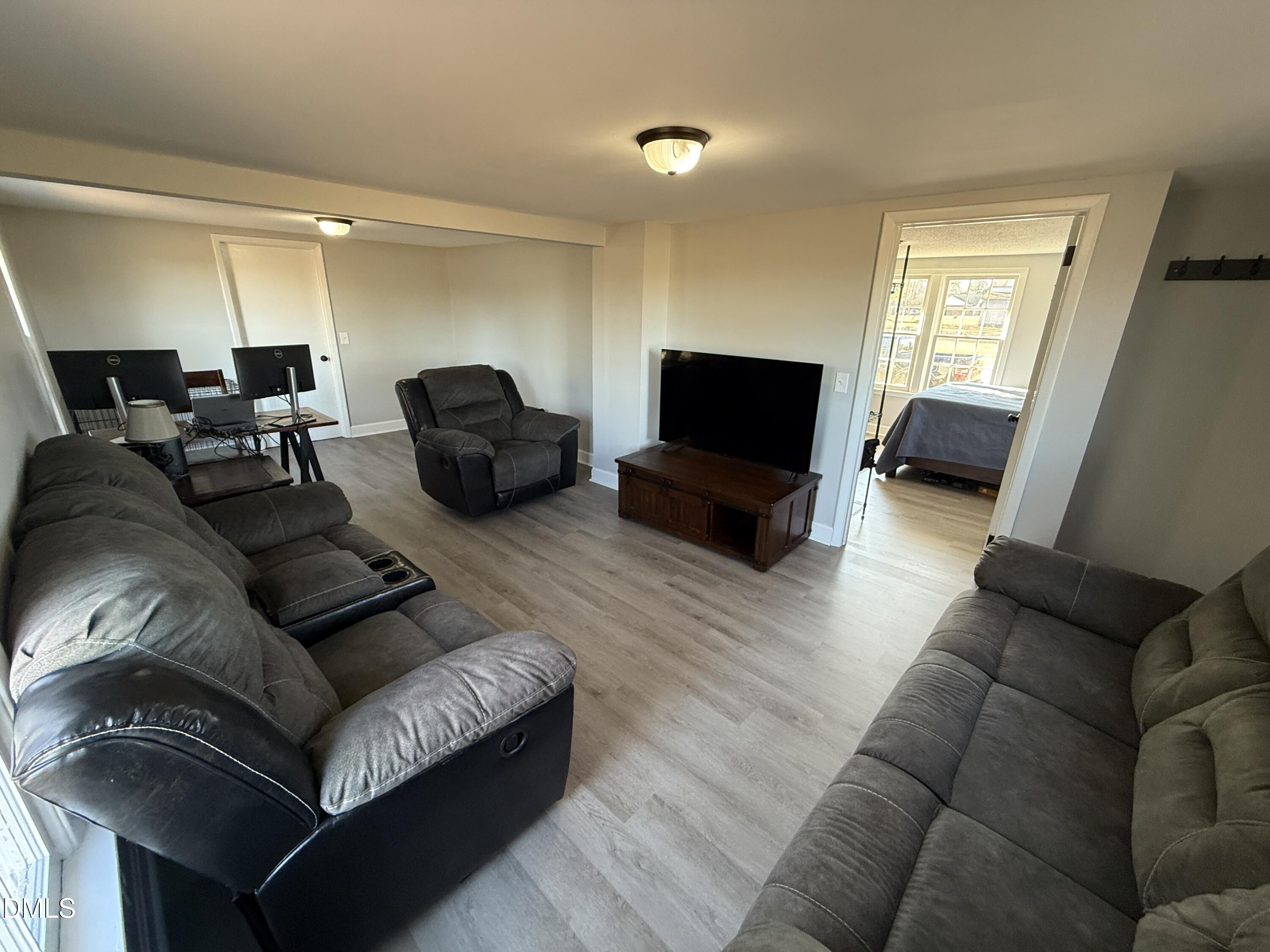 895 Stewart Road Four Oaks, NC 27524 - Photo 3 of 38 a living room with furniture and a flat screen tv