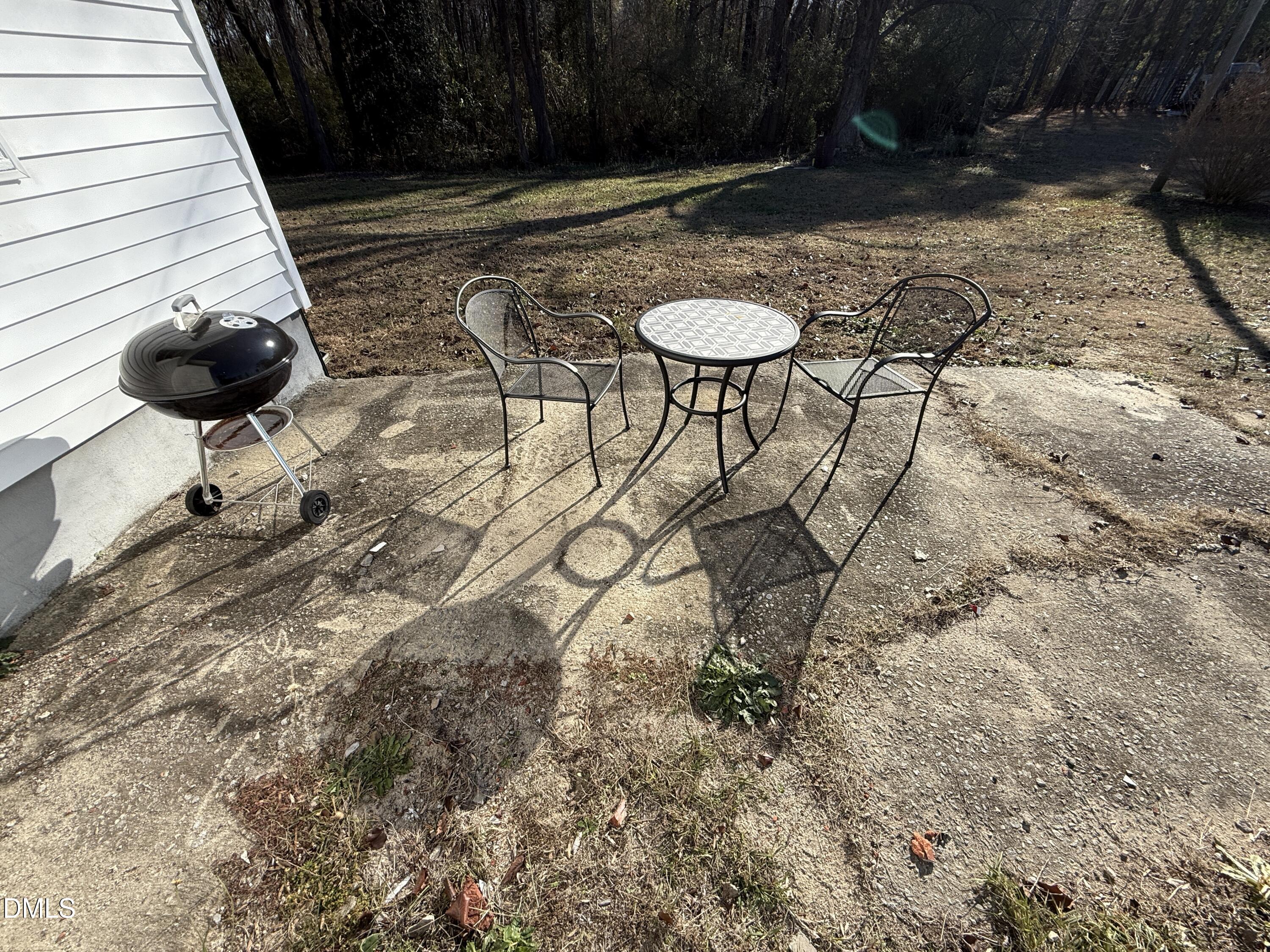 895 Stewart Road Four Oaks, NC 27524 - Photo 35 of 38 a backyard of a house with table and chairs