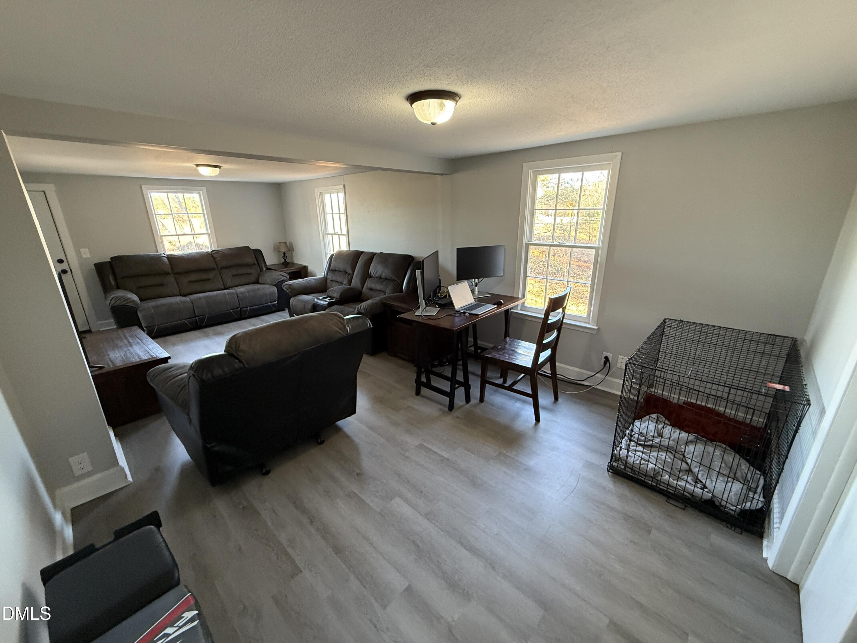 895 Stewart Road Four Oaks, NC 27524 - Photo 4 of 38 a living room with furniture and wooden floor