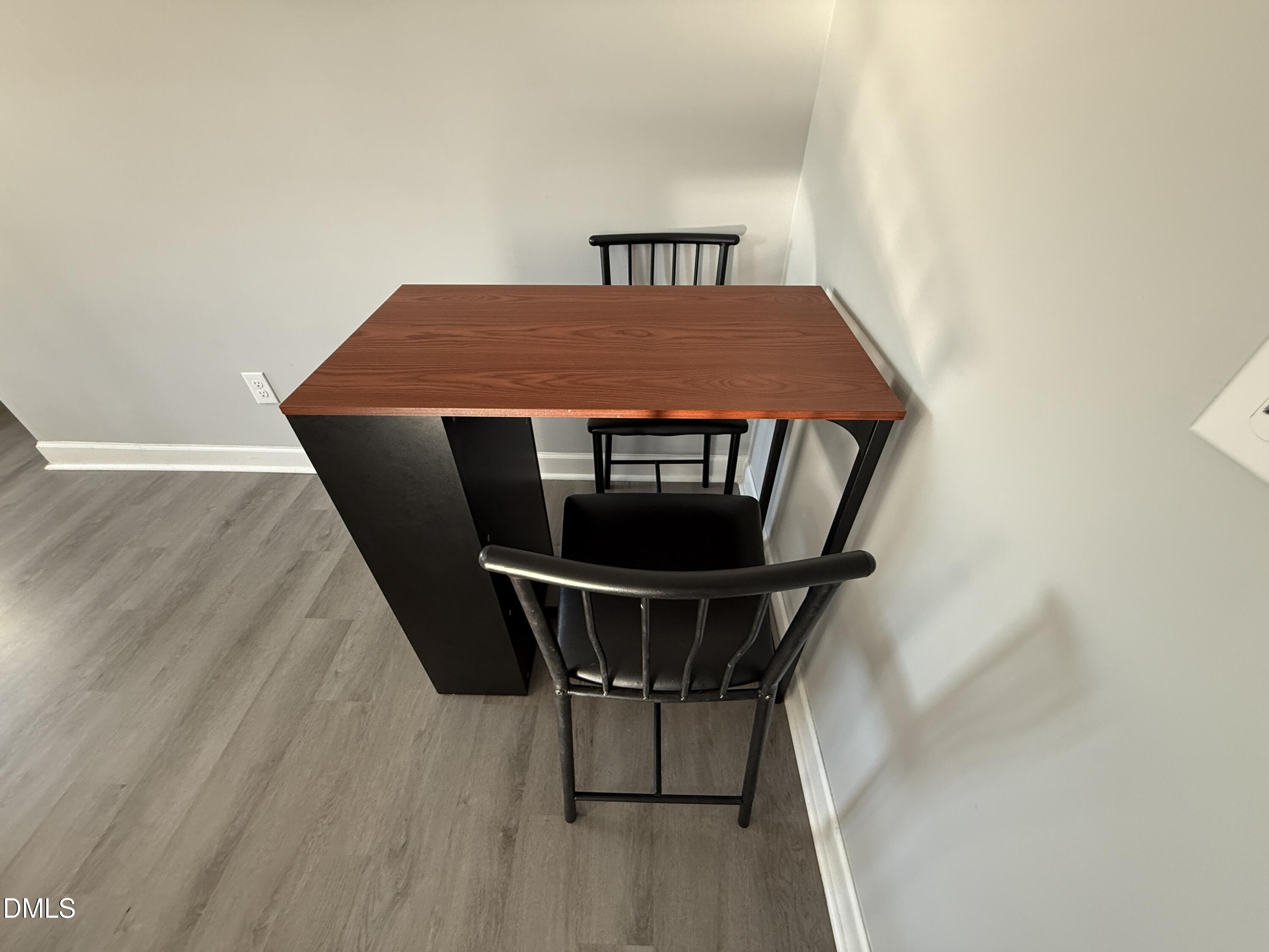 895 Stewart Road Four Oaks, NC 27524 - Photo 10 of 38 a room with table and wooden floor
