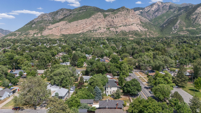 1256 24th Street Ogden, UT 84401 - Photo 31 of 34 Mountain backdrop framing a residential area with mature trees and a structured street grid