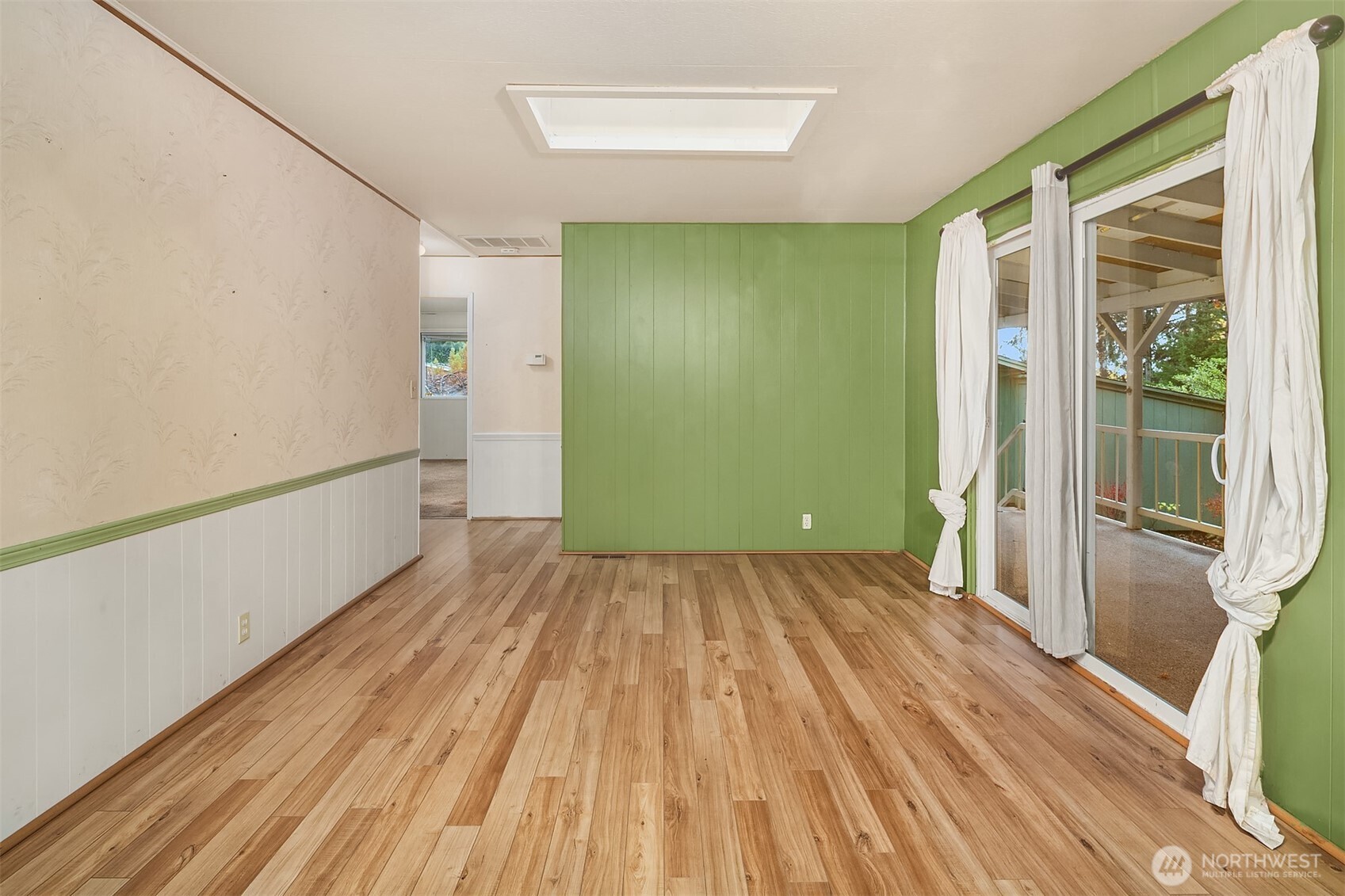 12800 Northeast 190th Place Bothell, WA 98011 - Photo 3 of 22 a view of an empty room with wooden floor and a window