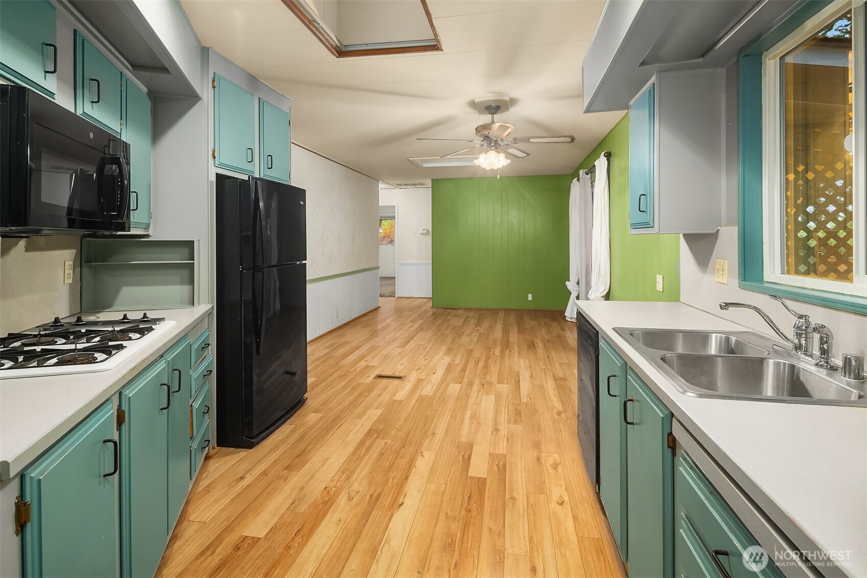 12800 Northeast 190th Place Bothell, WA 98011 - Photo 5 of 22 a kitchen with a sink a counter top space stainless steel appliances and cabinets