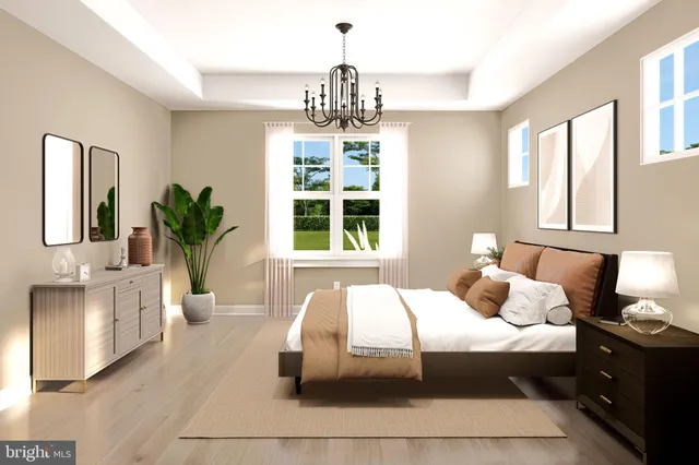 a bedroom with a large bed and a chandelier