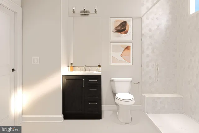 a bathroom with a toilet sink vanity and mirror