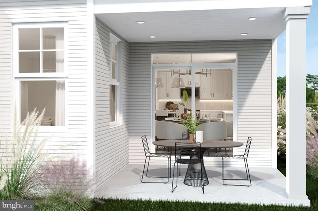 a view of a dining room with furniture and front door