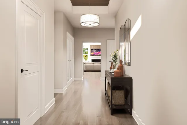a hallway with wooden floor and furniture