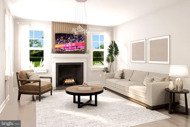 a living room with furniture a rug and a fireplace