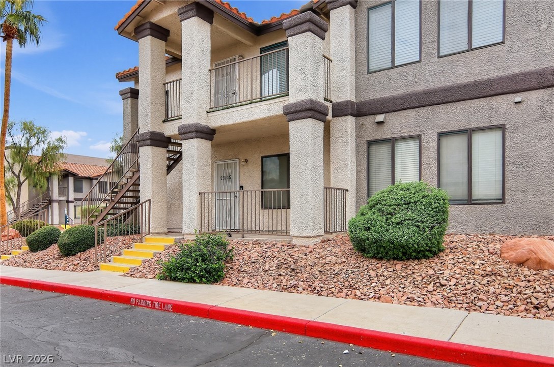 1575 West Warm Springs Road, Unit 2212 Henderson, NV 89014 - Photo 17 of 29 Multi-level stucco exterior showcases classic architectural columns and a tiled roofline.