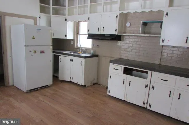 a kitchen with cabinets and white appliances