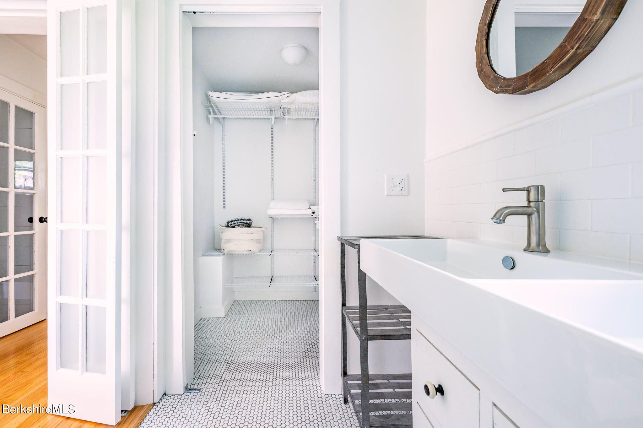 219 Shore Road Richmond, MA 01201 - Photo 12 of 28 a bathroom with a sink and a mirror