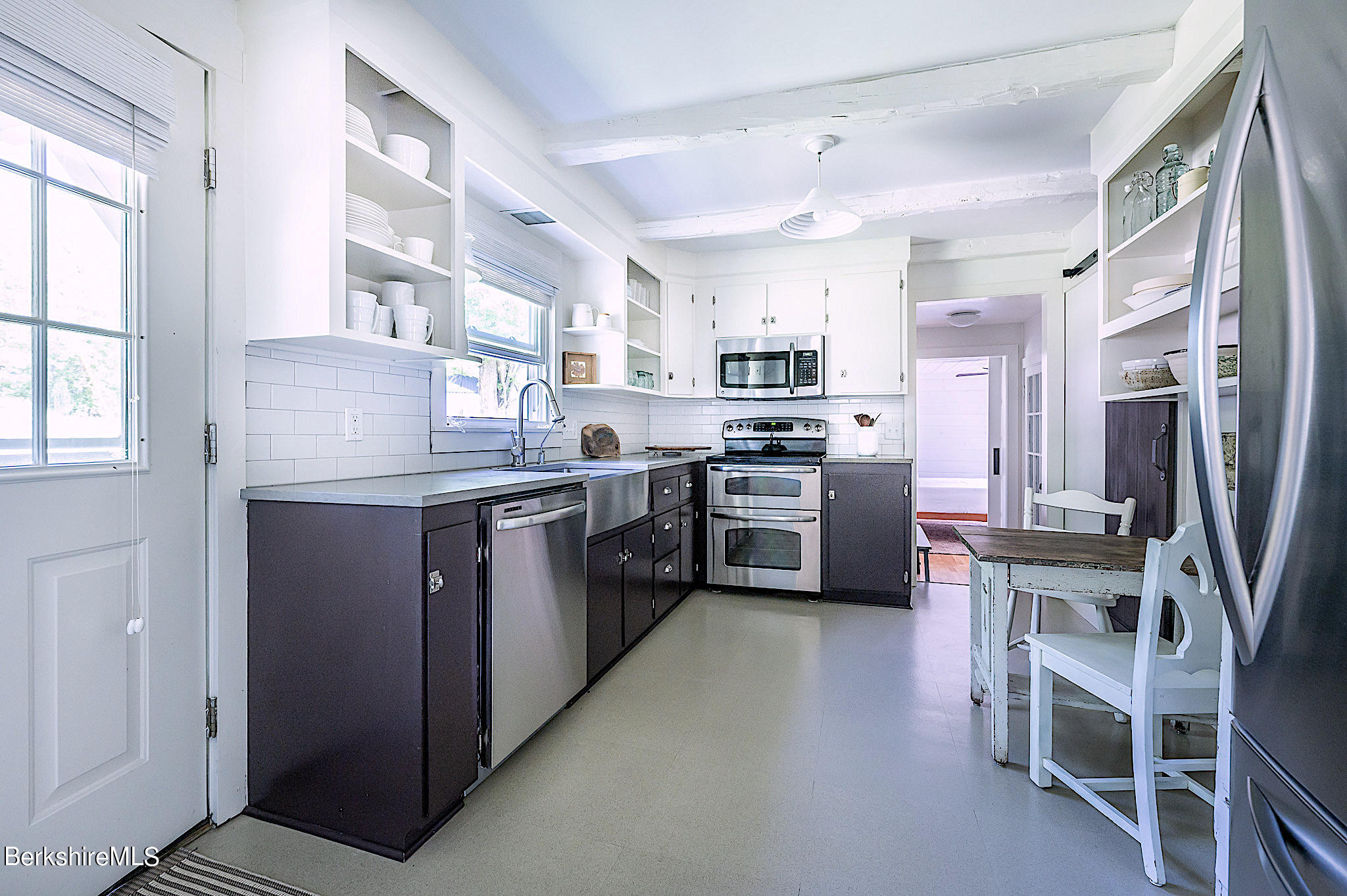 219 Shore Road Richmond, MA 01201 - Photo 7 of 28 a kitchen with cabinets a sink and stainless steel appliances
