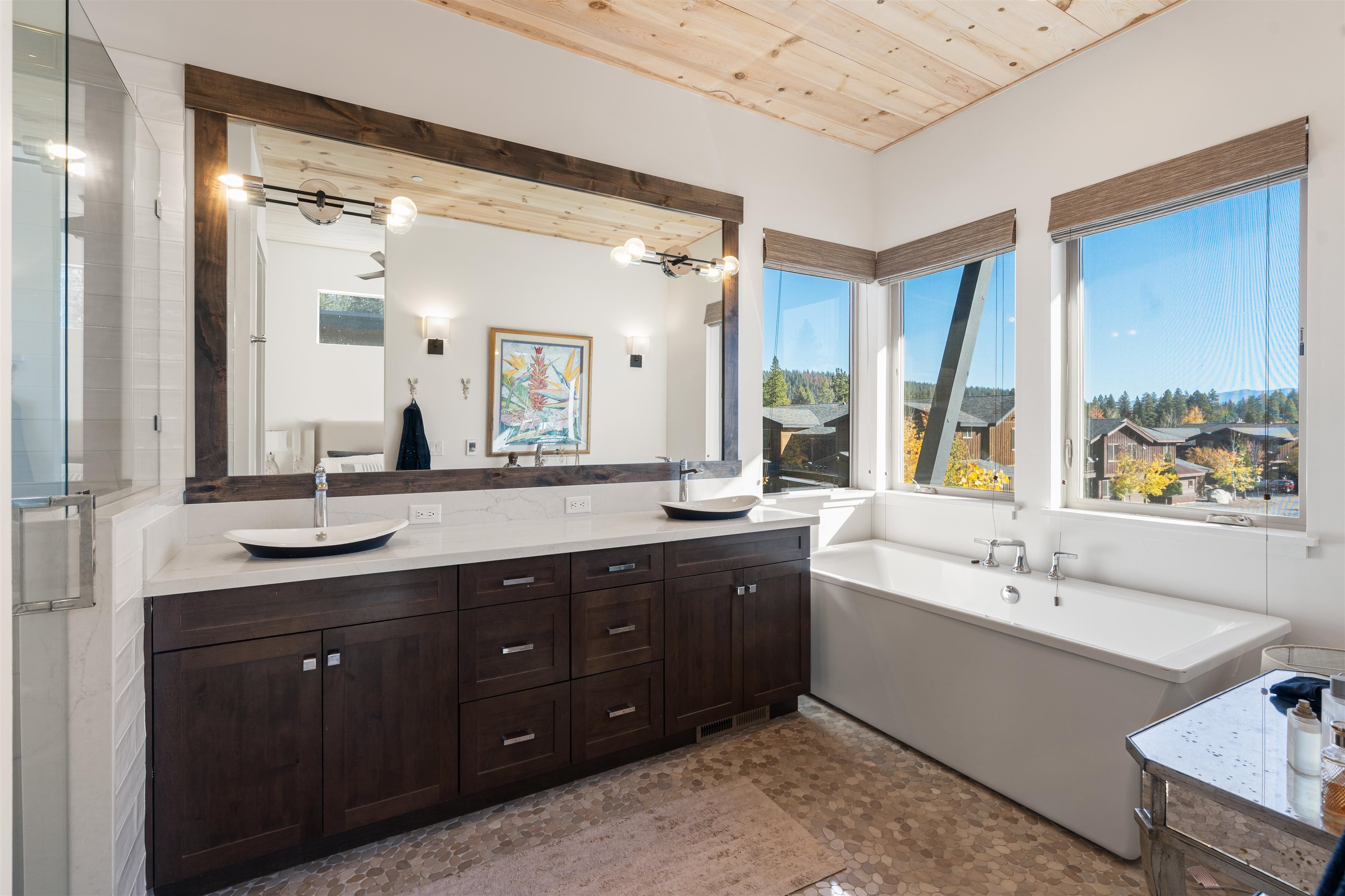 11658 McClintock Loop Truckee, CA 96161 - Photo 8 of 13 a spacious bathroom with a double vanity sink a large mirror and a bathtub