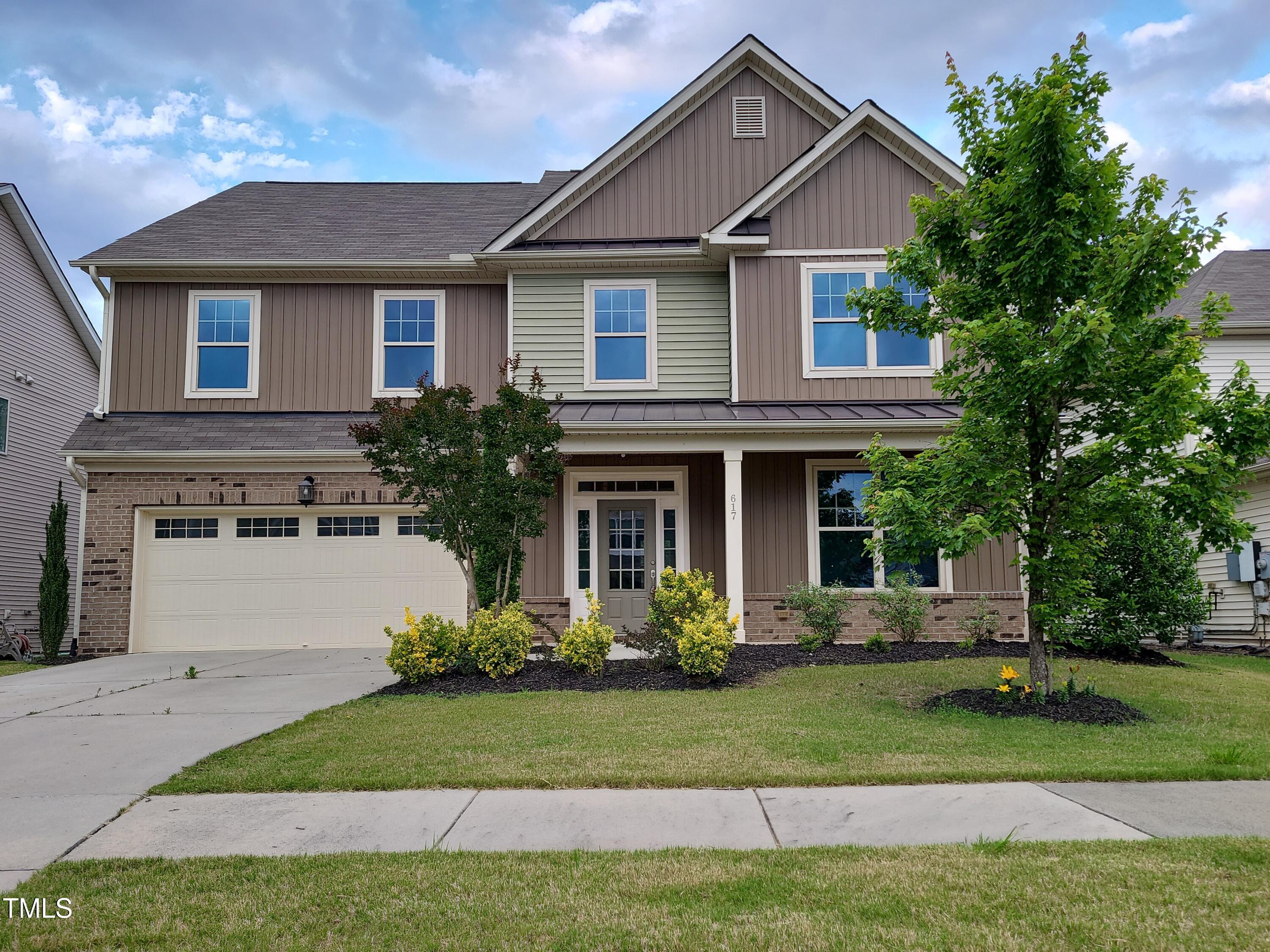 617 Hiddenbrook Drive Durham, NC 27703 - Photo 1 of 26 a front view of a house with a yard and trees