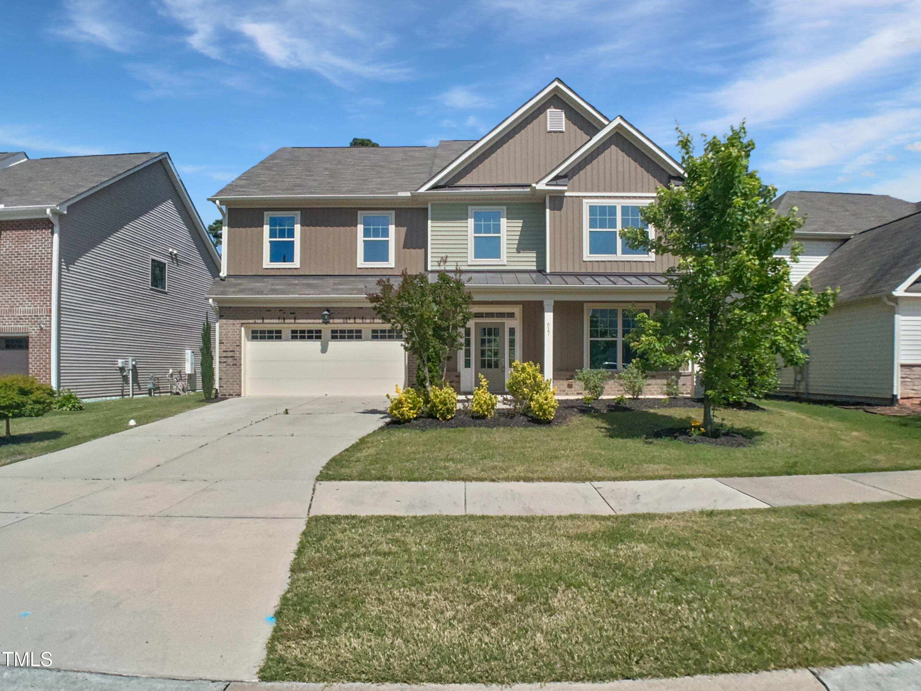 617 Hiddenbrook Drive Durham, NC 27703 - Photo 2 of 26 a front view of a house with a yard and garage