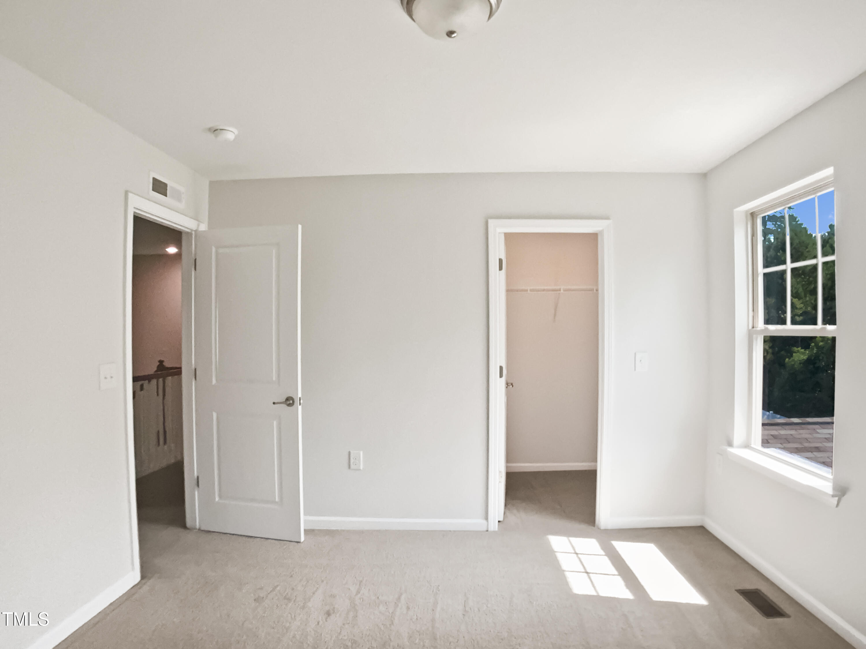 617 Hiddenbrook Drive Durham, NC 27703 - Photo 21 of 26 a view of empty room with windows and wardrobe