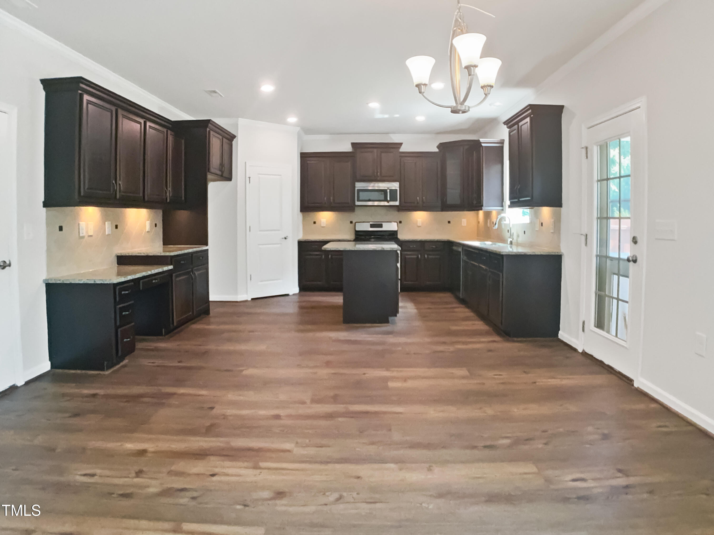 617 Hiddenbrook Drive Durham, NC 27703 - Photo 9 of 26 a large kitchen with a large counter top appliances and cabinets