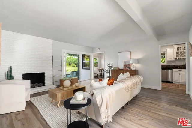 a living room with furniture fireplace and a table
