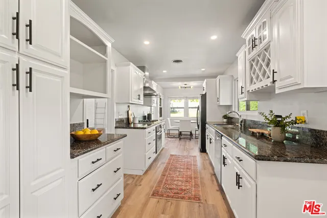 a kitchen with stainless steel appliances granite countertop a sink and cabinets