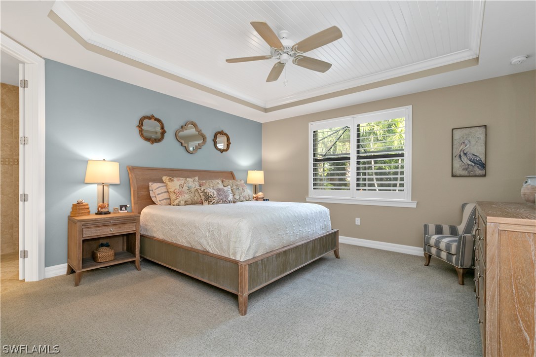 10832 Dennington Road Fort Myers, FL 33913 - Photo 14 of 34 a bed sitting in a spacious bedroom next to a window