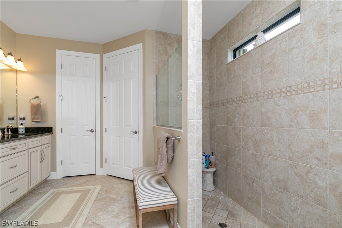 10832 Dennington Road Fort Myers, FL 33913 - Photo 16 of 34 a bathroom with a granite countertop sink a toilet and shower