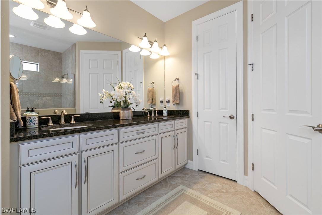 10832 Dennington Road Fort Myers, FL 33913 - Photo 17 of 34 a bathroom with a sink and a mirror