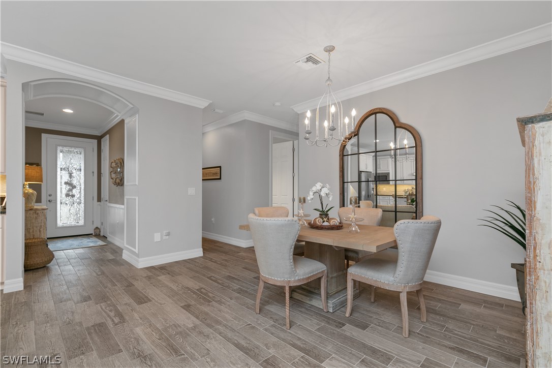 10832 Dennington Road Fort Myers, FL 33913 - Photo 7 of 34 a view of a dining room with furniture and wooden floor
