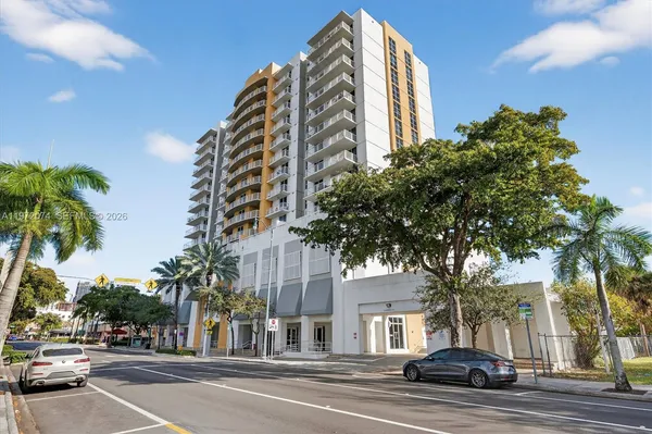a view of a tall building next to a road