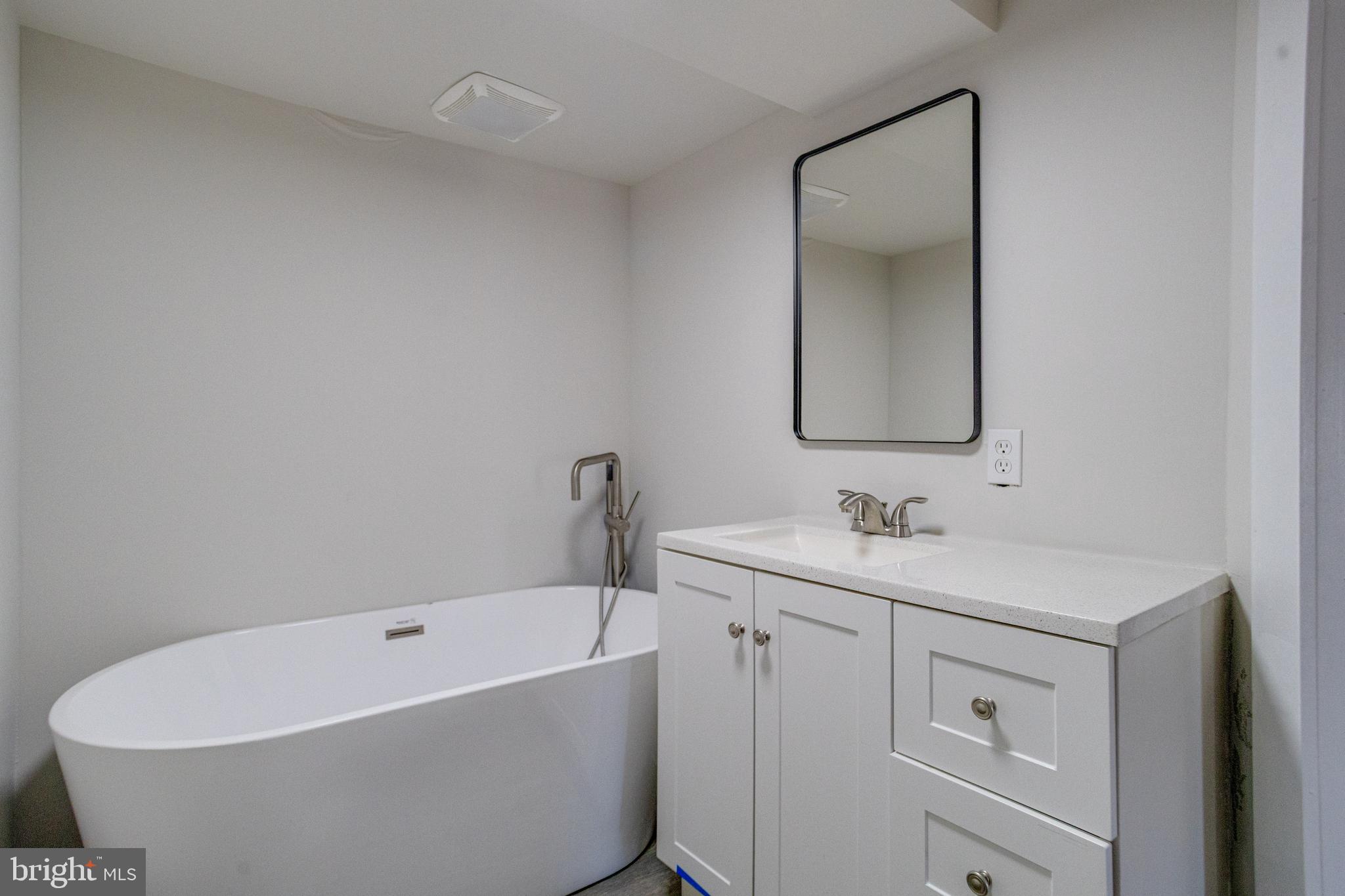 5878 Belair Road Baltimore, MD 21206 - Photo 21 of 41 a bathroom with a toilet sink and mirror