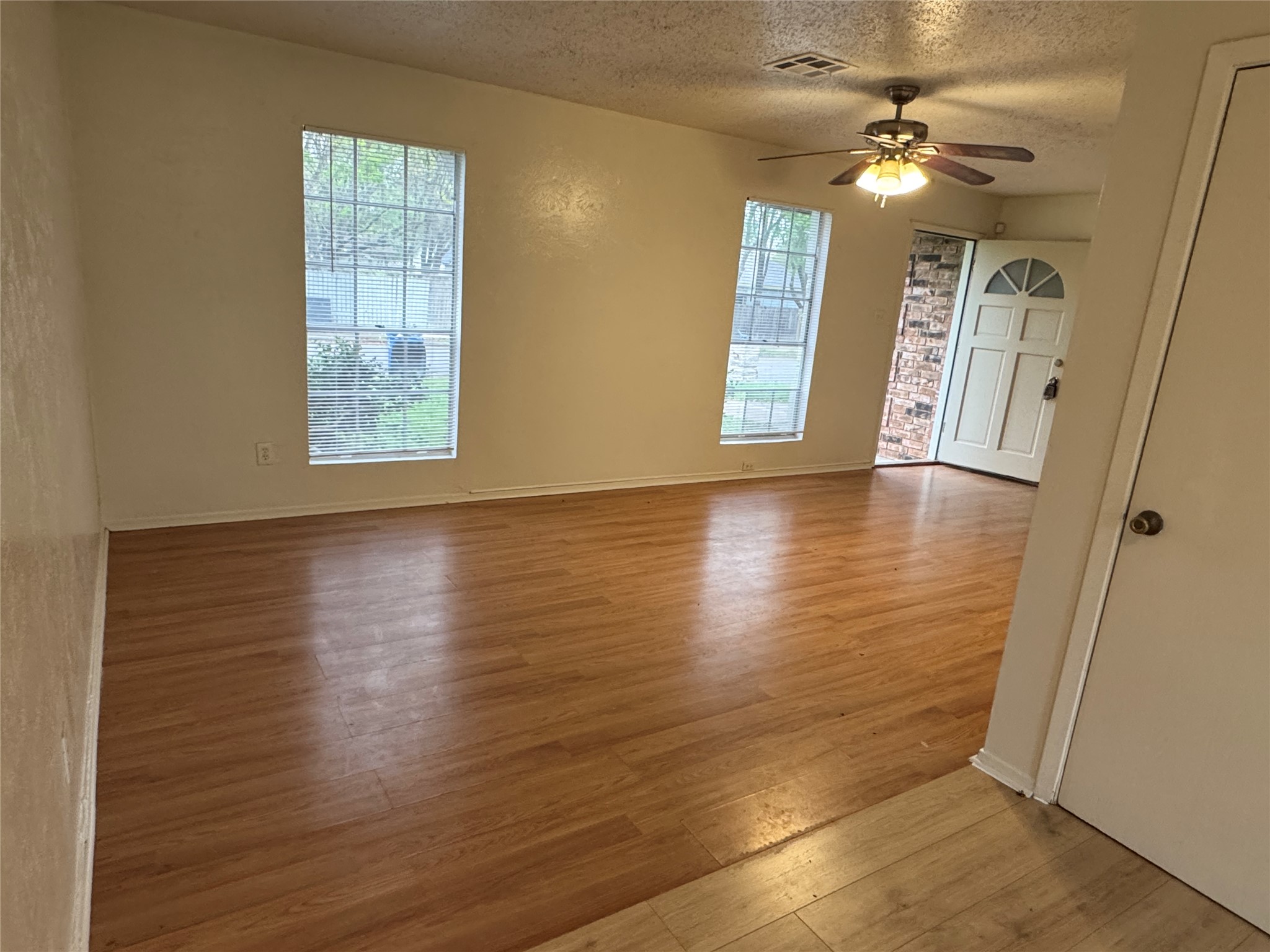5810 Hammermill Run Austin, TX 78744 - Photo 7 of 10 Spare room with visible vents, wood finished floors, and a ceiling fan