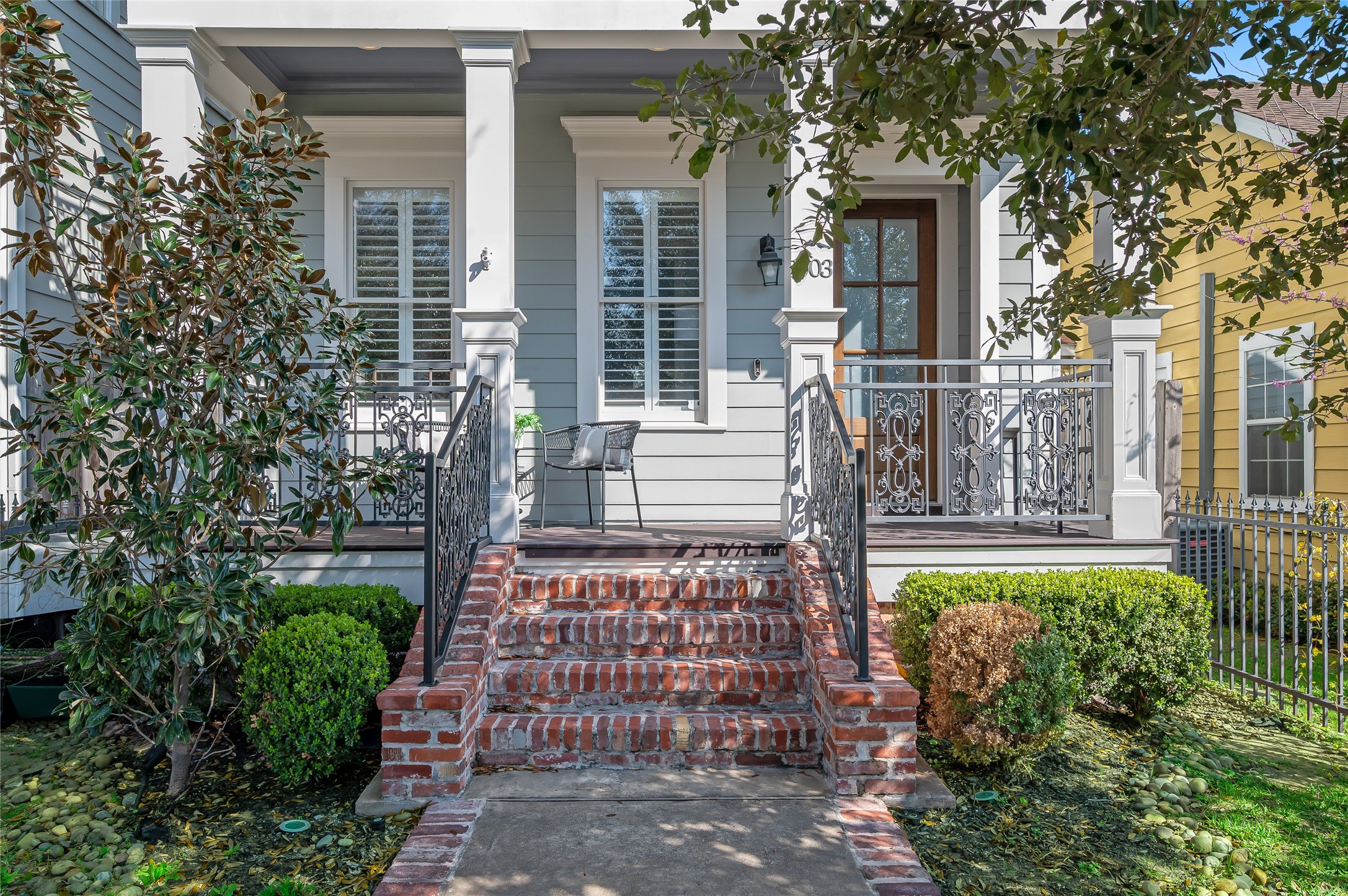 1003 East 25th Street Houston, TX 77009 - Photo 2 of 33 A brick and concrete walk way guides you to an inviting front porch nestled under the canopy of mature oaks.
