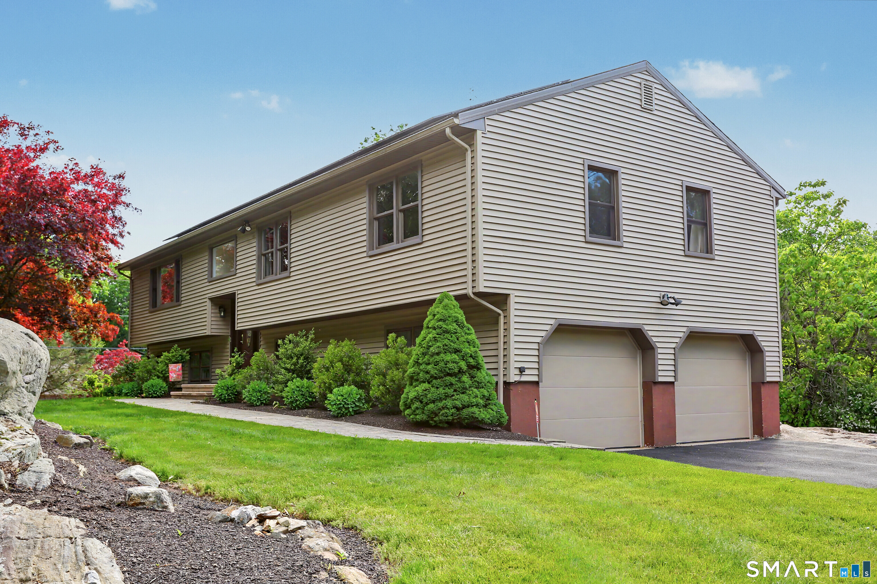 632 Wheelers Farm Road Orange, CT 06477 - Photo 38 of 39 a front view of a house with a yard and garage