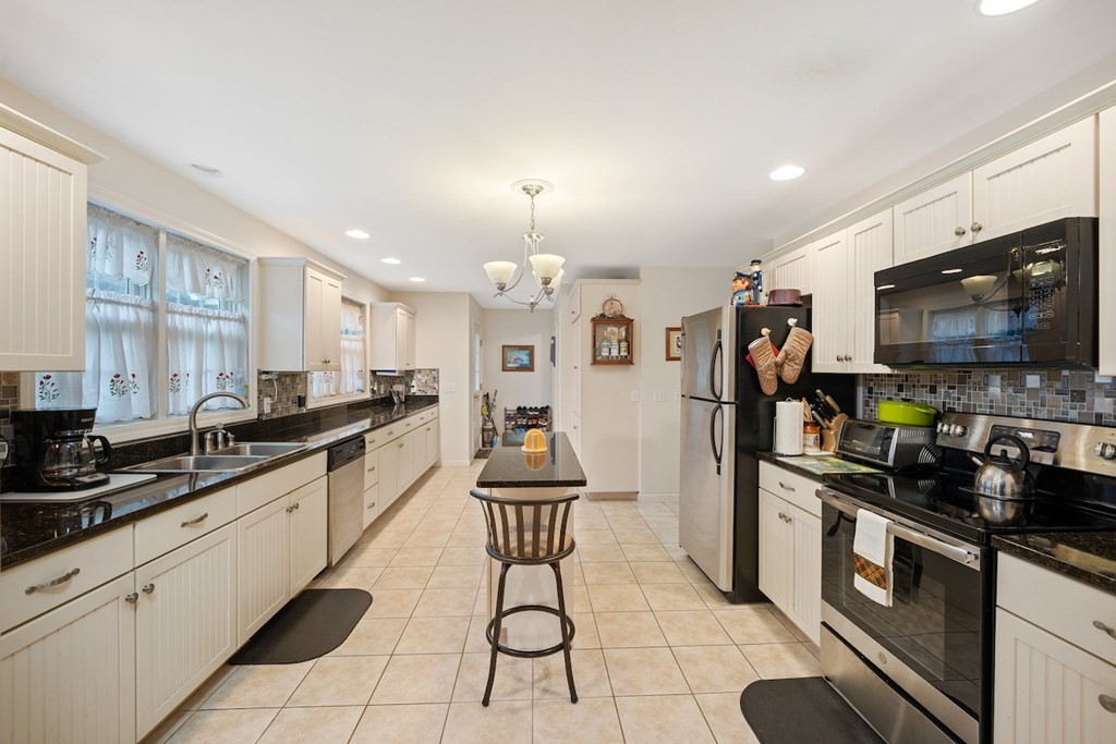90 Greenwich Road Ware, MA 01082 - Photo 14 of 41 a kitchen with stainless steel appliances a sink a stove top oven a counter space and cabinets