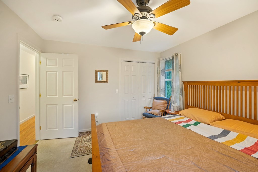 90 Greenwich Road Ware, MA 01082 - Photo 24 of 41 a bedroom with a bed and a chandelier