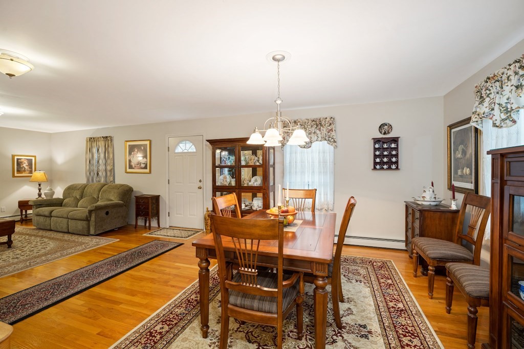 90 Greenwich Road Ware, MA 01082 - Photo 9 of 41 a dining room with furniture a rug and a chandelier