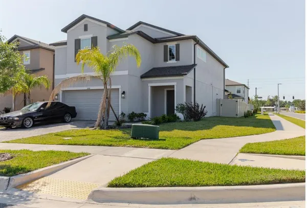 a front view of a house with swimming pool and porch