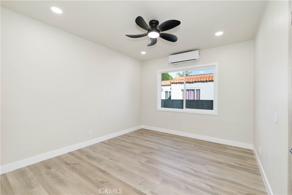 604 South Burris Avenue Compton, CA 90221 - Photo 16 of 25 an empty room with wooden floor and ceiling fan