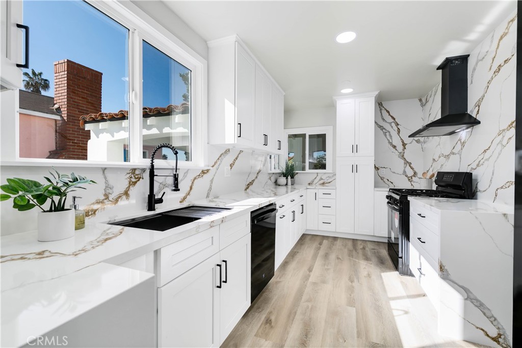 604 South Burris Avenue Compton, CA 90221 - Photo 10 of 25 a kitchen with stainless steel appliances granite countertop a sink stove and refrigerator