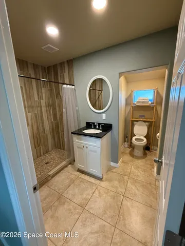 a bathroom with a sink a toilet and a shower