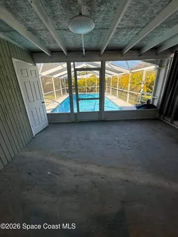 a view of an empty room with windows