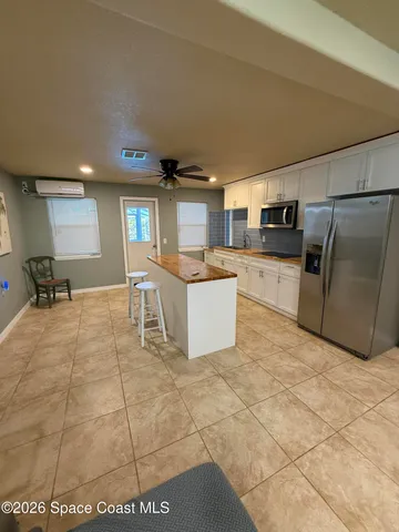 a large kitchen with cabinets and a stove top oven
