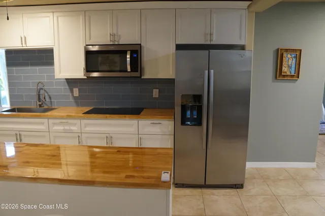 a kitchen with a refrigerator and microwave