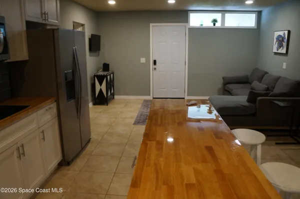 a view of a kitchen with refrigerator and a stove