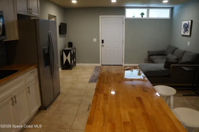 a view of a kitchen with refrigerator and a stove