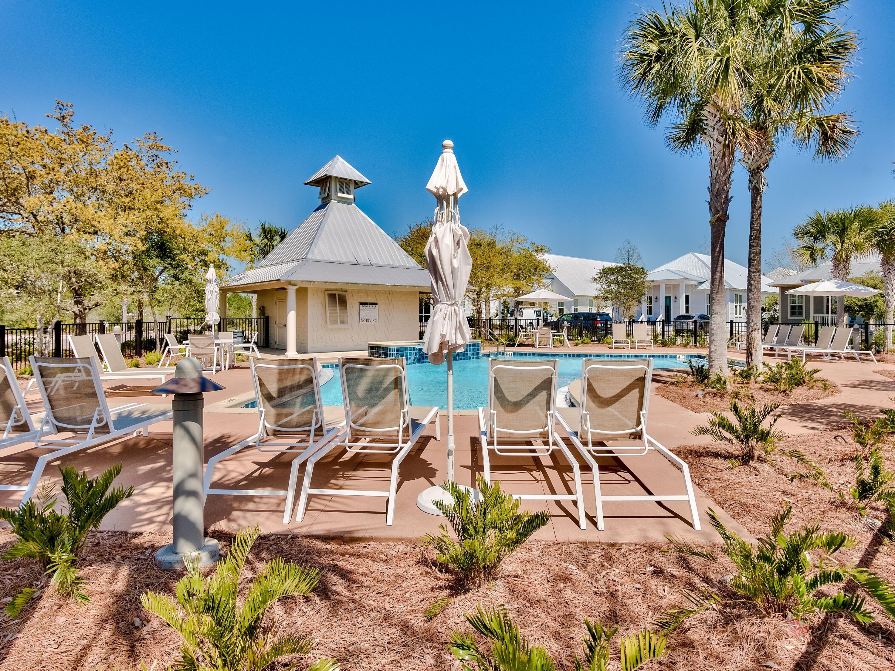 Lot 162 Gulf Walk Santa Rosa Beach, FL 32459 - Photo 46 of 48 a view of a patio with table and chairs potted plants and a palm tree