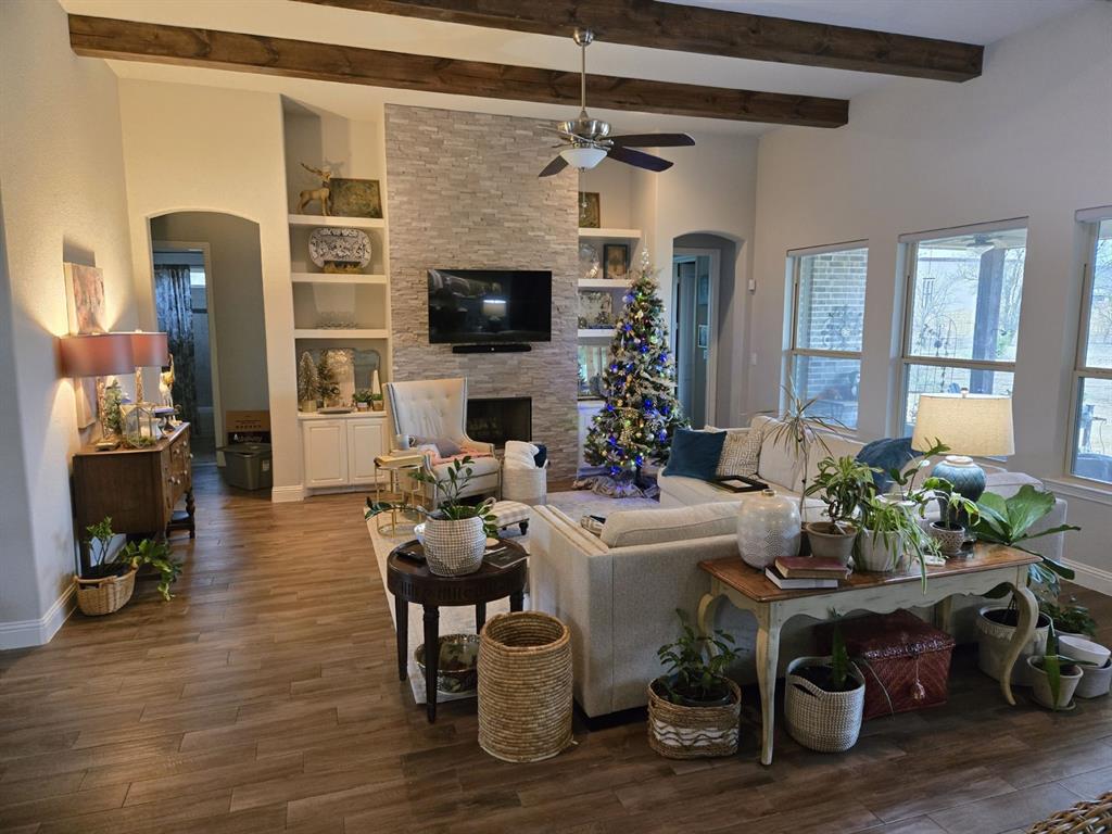 2321 Kimberly Lane Midlothian, TX 76065 - Photo 4 of 10 a living room with furniture a flat screen tv and a fireplace